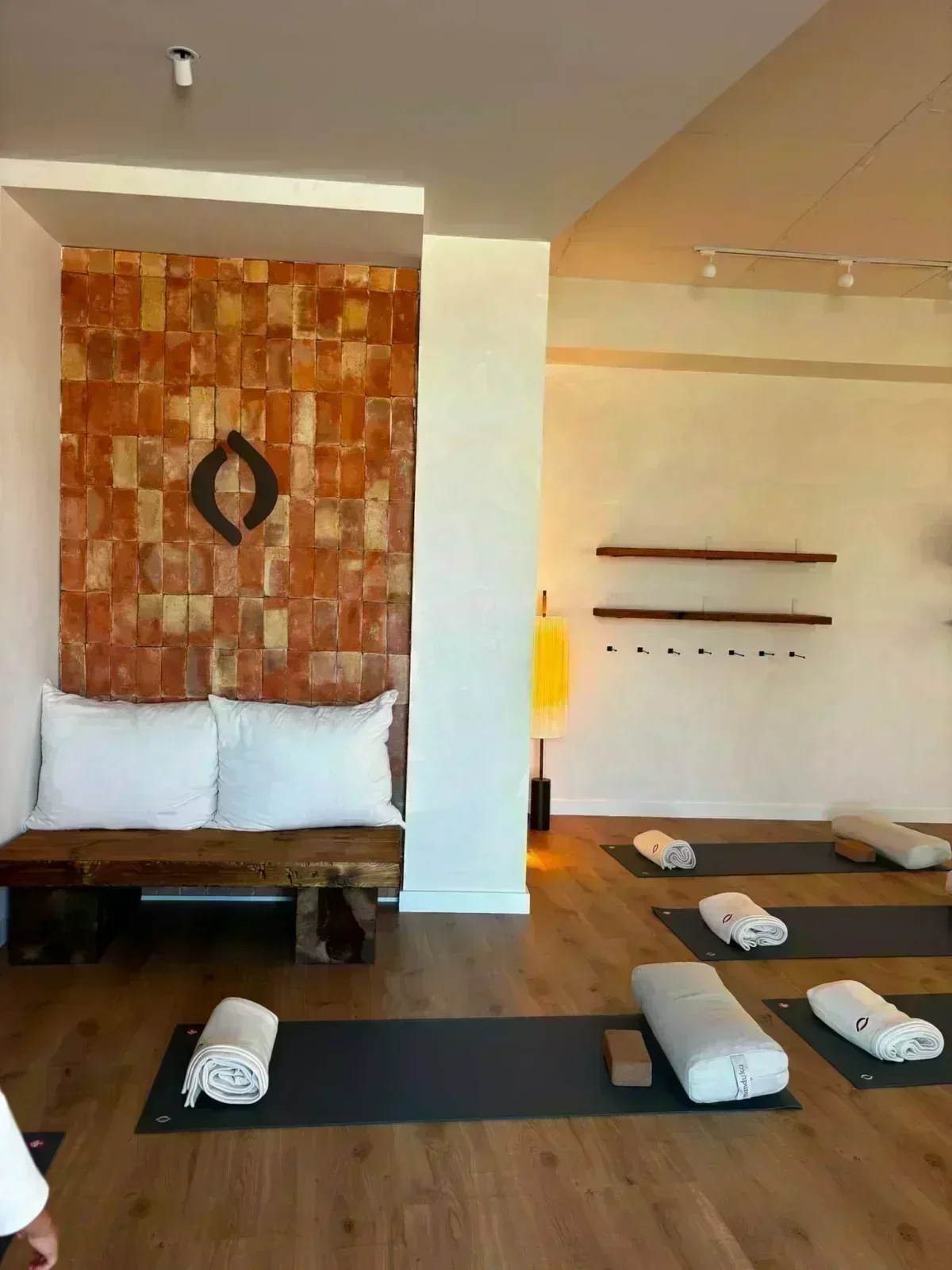 Corner with brick wall and YogaBond logo